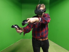 Postmedia reporter Nick Dunne plays VR games at Colony VR in Ottawa Friday Feb 16, 2018.