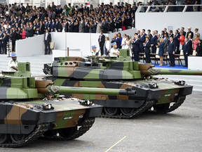 U.S. President Donald Trump watches the annual Bastille Day military parade on the Champs-Elysees in Paris on July 14, 2017. The event has inspired Trump to want to hold a similar parade in Washington.