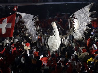 Athletes surround a sculpture during the closing ceremony of the 2018 Winter Olympics in Pyeongchang, South Korea, Sunday, Feb. 25, 2018.