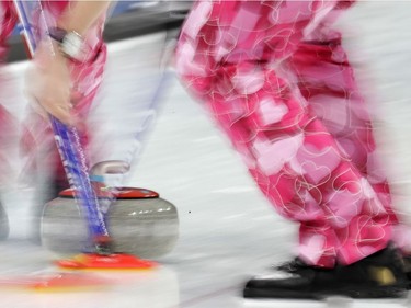 Norway men's curling team wear pants with heart-shape prints during their match against Japan.