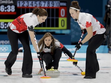 Canada's skip Rachel Homan, center, watches teammates sweep the ice during a women's curling match against Denmark at the 2018 Winter Olympics in Gangneung, South Korea, Friday, Feb. 16, 2018.