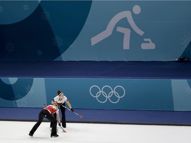 Canada's Emma Miskew, left, and Joanne Courtney, sweeps the ice during a women's curling match against United States at the 2018 Winter Olympics in Gangneung, South Korea, Saturday, Feb. 17, 2018.
