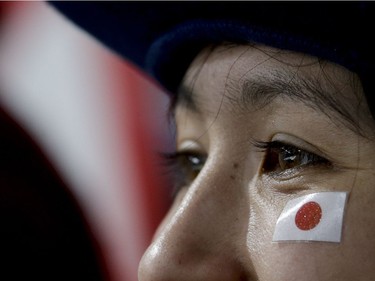 A Japanese fan watches women's curling matches at the 2018 Winter Olympics in Gangneung, South Korea, Saturday, Feb. 17, 2018.