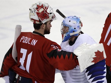 Kevin Poulin (31), of Canada, greets Matt Dalton (1), of South Korea, after the preliminary round of the men's hockey game at the 2018 Winter Olympics in Gangneung, South Korea, Sunday, Feb. 18, 2018. Canada won 4-0.