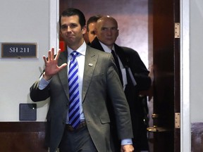 Donald Trump Jr., son of U.S. President Donald Trump and executive vice president of Trump Organization Inc. (centre) exits an interview with the Senate Intelligence Committee in Washington on Dec. 13, 2017.
