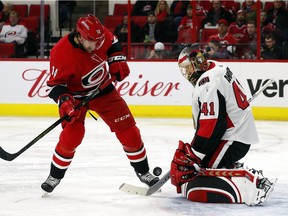 Senators goalie Craig Anderson makes a save despite the presence of Hurricanes forward Justin Williams in front of his crease during Tuesday's game at Raleigh, N.C.