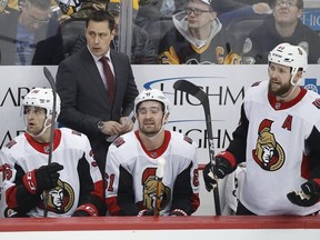 Senators coach Guy Boucher stands behind Colin White (36), Mark Stone (61) and Zack Smith (15) during the first period of a game in Pittsburgh on Feb. 13.