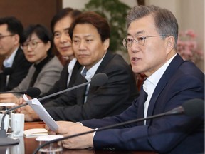 South Korean President Moon Jae-in, right, speaks during a meeting with his top aides.