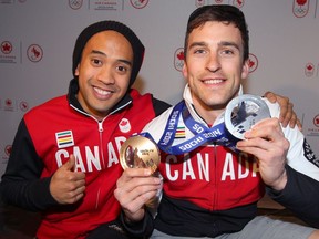 Gilmore Junio, left, and Denny Morrison pose with medals after arriving back in Calgary following the 2014 Sochi Winter Olympics.    Jim Wells/Postmedia
