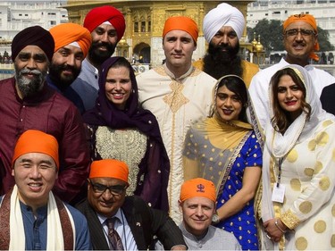 Prime Minister Justin Trudeau, centre, stands beside Surrey Centre MP Randeep Sarai, top middle right, as they join fellow MPs for a group photo while visiting the Golden Temple in Amritsar, India on Wednesday, Feb. 21, 2018.