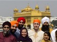 Prime Minister Justin Trudeau, centre, stands beside Surrey Centre MP Randeep Sarai, top centre right, as they join fellow MPs for a group photo while visiting the Golden Temple in Amritsar, India on Wednesday, Feb. 21, 2018.