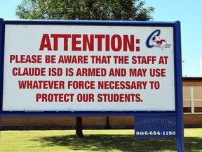 This August 2016 photo shows a sign outside a school in Claude, Texas, which Claude ISD posts outside their schools. In the aftermath of yet another mass school shooting, President Donald Trump says that if one of the victims, a football coach, had been armed "he would have shot and that would have been the end of it." Revisiting an idea he raised in his campaign, Trump's comments in favor of allowing teachers to be armed come as lawmakers in several states are wrestling with the idea, including in Florida, where the 17 most recent school shooting victims are being mourned.