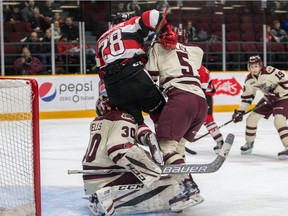 Defenceman Nikita Okhotyuk collies with Petes goaltender Dylan Wells. He was assessed a minor penalty for goaltender interference on the play.