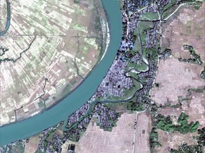 This Dec. 2, 2017, satellite image provided by DigitalGlobe, shows the village of Myar Zin, about 30 kilometers (19 miles) north of Maungdaw, Rakhine state, Myanmar. Satellite images of Myanmar's troubled Rakhine state, released to The Associated Press by Colorado-based DigitalGlobe on Friday, Feb. 23, 2018, show that dozens of empty villages and hamlets have been completely leveled by authorities in recent weeks, far more than previously reported. The villages were all set ablaze in the wake of violence last August, when a brutal clearance operation by security forces drove hundreds of thousands of Rohingya into exile in Bangladesh. (DigitalGlobe via AP)