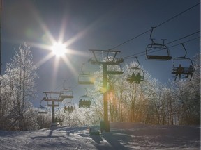 A file photo shows skiers riding a lift at Camp Fortune.