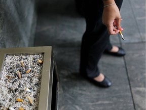 A woman smoking a cigarette.