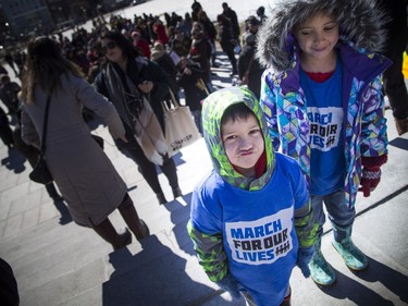 March For Our Lives Ottawa started on Parliament Hill Saturday March 24, 2018, making its way over to Major's Hill Park. People of Ottawa took to the streets joining with others all over North America to demand lives and safety become a priority and to end gun violence and mass shootings in schools.  Seven-year-old Sadie looks over to her little brother four-year-old Felix Stewart-Troy.  Ashley Fraser/Postmedia