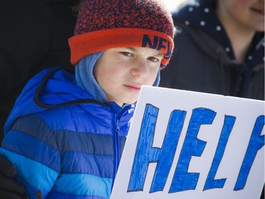 March For Our Lives Ottawa started on Parliament Hill Saturday March 24, 2018, making its way over to Major's Hill Park. People of Ottawa took to the streets joining with others all over North America to demand lives and safety become a priority and to end gun violence and mass shootings in schools. Ten-year-old Christian Ryan-Nicholas stands with a poster during the march.   Ashley Fraser/Postmedia