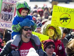 Four-year-old Felix Stewart-Troy, sitting on the shoulders of his father, Alex Lovell-Troy, was one of several hundred Ottawa participants in the local version the continent-wide March for our Lives protest.