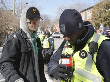 Police check beverages for alcohol at a St. Patrick's Day party on Russell Avenue in the Sandy Hill Neigbourhood of Ottawa on Saturday, March 17, 2018.