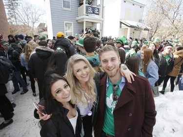 Hannah Cote, left, Samantha Hint, centre, and Devon Scott take part in a St. Patrick's Day party on Russell Avenue in the Sandy Hill Neigbourhood of Ottawa on Saturday, March 17, 2018.