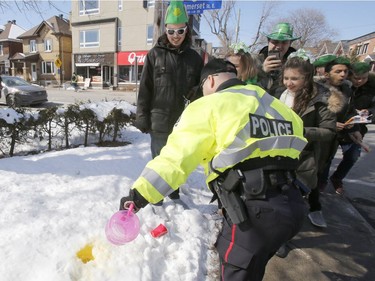 Police were on hand to monitor festivities at a St. Patrick's Day party on Russell Avenue in the Sandy Hill Neigbourhood of Ottawa on Saturday, March 17, 2018. Police confiscated alcohol from some of those on hand.