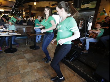 Mariel, right, and Jacquelin Enright of the Enright Family dance at D'Arcy McGee's in Kanata on St. Patrick's Day, Saturday, March 17, 2018.