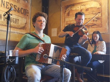 Isaac Enright, left, Louis Schryer, centre, and Agnes Enright of the Enright Family perform at D'Arcy McGee's in Kanata on St. Patrick's Day, Saturday, March 17, 2018.