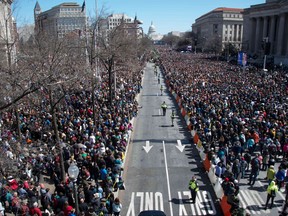 People take part in the March For Our Lives rally against gun violence in Washington, DC on March 24, 2018.