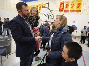 Innes Ward Coun. Jody Mitic speaks with Julie Tardif and her son, Noah, 8, while holding his daughter Kierah, 6, at the Innes Ward Easter Pancake Breakfast in Orleans on Saturday. Mitic announced at the breakfast that he will not be seeking re-election/