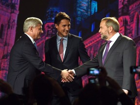 Conservative leader Stephen Harper, left, and NDP leader Tom Mulcair shake hands as Liberal leader Justin Trudeau looks on during their introduction prior to the Globe and Mail hosted leaders' debate in Calgary on Sept. 17, 2015.