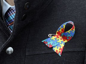 A man wears a special ribbon in support of autism awareness.