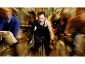 Fitness and life coach Sophie Belisle (centre) is a whirlwind of energy as she leads her spin class at Goodlife.