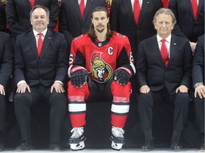 Senators captain Erik Karlsson is flanked by general manager Pierre Dorion and owner Eugene Melnyk in the front row of the team photo taken Wednesday at Canadian Tire Centre. Julie Oliver/Postmedia