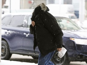 Waseem Shaheen covers his face and rushes into the Ottawa Courthouse.