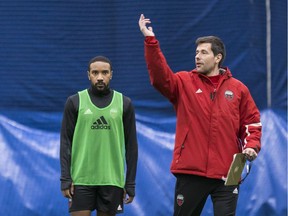 With Jamar Dixon, left, looking on, Fury FC head coach Nikola Popovic makes a point during a practice earlier in training camp. Errol McGihon/Postmedia