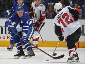 Leo Komarov of the Maple Leafs tries to block a shot by Senators defenceman Thomas Chabot during a game on Feb. 10.