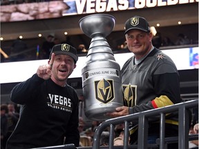 Vegas Golden Knights fans Mike Forizs, left, and Derek Frank pose with a homemade replica of the Stanley Cup before Tuesday's home game against the Kings.