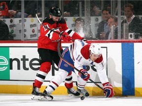 Canadiens' Brendan Gallagher is checked by Devils' Kyle Palmieri Tuesday night in Newark, N.J. Gallagher missed Wednesday's practice for a therapy day.