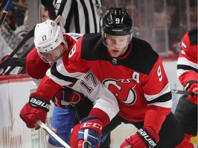 Rinat Valiev of the Montreal Canadiens and Taylor Hall of the New Jersey Devils battle for the puck during the second period.