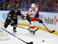 Flames forward Curtis Lazar, right, tries to beat Ryan O'Reilly of the Sabres to a puck in a game in Buffalo on Wednesday.