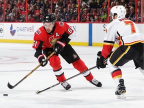 Mark Stone of the Senators skates with the puck against T.J. Brodie of the Flames in the second period of last Friday's game in Ottawa. Stone was injured when Calgary's Micheal Ferland fell into his leg from behind later in the contest.