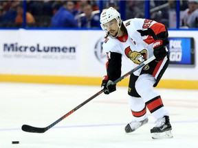 Erik Karlsson of the Senators passes the puck to a teammate during Tuesday's game against the LIghtning.