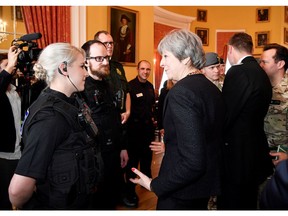 British Prime Minister Theresa May speaks to first responders in Salisbury who attended to former Russian intelligence officer Sergei Skripal and his daughter Yulia after they were poisoned with a nerve agent.