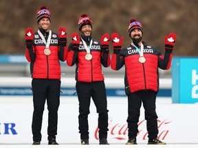 PYEONGCHANG-GUN, SOUTH KOREA - MARCH 18:  Brian McKeever (Center) and his guide Graham Nishikawa (L) and Collin Cameron of team Canada celebrate after winning the Bronze medal for the 4x2.5km open relay cross-country during day nine of the PyeongChang 2018 Paralympic Games on March 18, 2018 in Pyeongchang-gun, South Korea.