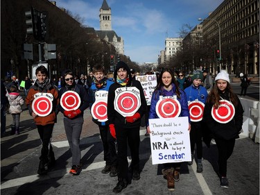 WASHINGTON, DC - MARCH 24:  Students from Centreville, Virginia wear targets on their chests as they arrive for the March for Our Lives rally March 24, 2018 in Washington, DC. Hundreds of thousands of demonstrators, including students, teachers, and parents are expected to gather for the anti-gun violence rally, spurred largely by the shooting that took place on Valentine's Day at Marjory Stoneman Douglas High School in Parkland, Florida where 17 people died.