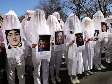 NEW YORK, NY - MARCH 24:  Holding pictures of victims killed in gun violence, thousands of people, many of them students, march against gun violence in Manhattan during the March for Our Lives rally on March 24, 2018 in New York City. More than 800 March for Our Lives events, organized by survivors of the Parkland, Florida school shooting on February 14 that left 17 dead, are taking place around the world to call for legislative action to address school safety and gun violence.