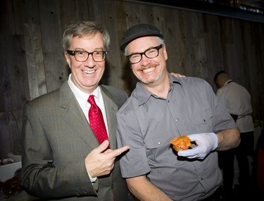 Mayor Jim Watson jokes with chef Jim Foster from Pelican Seafood Market and Grill.