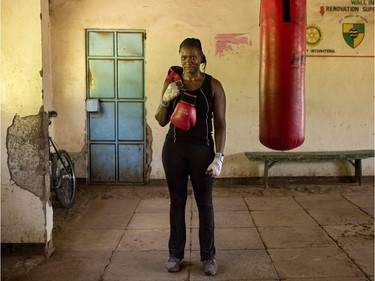 To mark the occasion of International Women's Day on March 8, 2018 AFP presents a series of 45 photos depicting women performing roles or working in professions more traditionally held by men.  More images can be found in www.afpforum.com  Search SLUG  "WOMEN-DAY -PACKAGE".  Sarah Achieng a 31 year-old professional boxer and sports administrator poses after her training session at Kariobangi social hall gym in Nairobi on February 27, 2018.  In the ring, battling flames or lifting off into space, women have entered professions generally considered as men's jobs. For International Women's Day, AFP met with women breaking down the barriers of gender-bias in the work world.