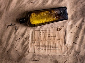 This undated photo received courtesy from Kym Illman on March 7, 2018 shows a bottle and the almost 132-year-old message it contained, that was found near Wedge Island.